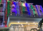 KPA Palace building lit with colourful festive lights at night